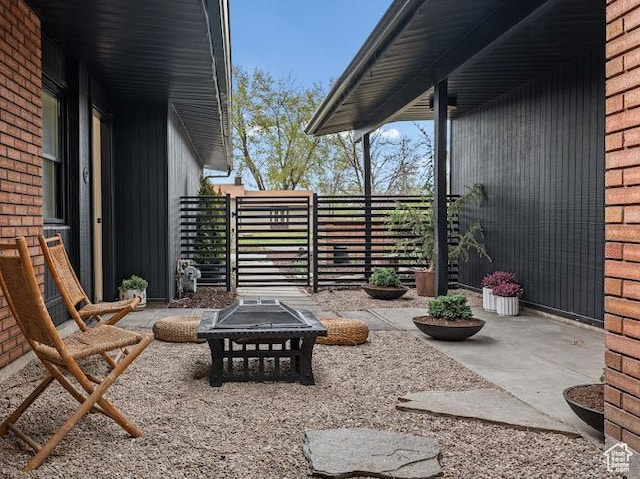 976 E Hyland Lake Dr, Murray, UT 84121 - view of patio / terrace with a fire pit and fence