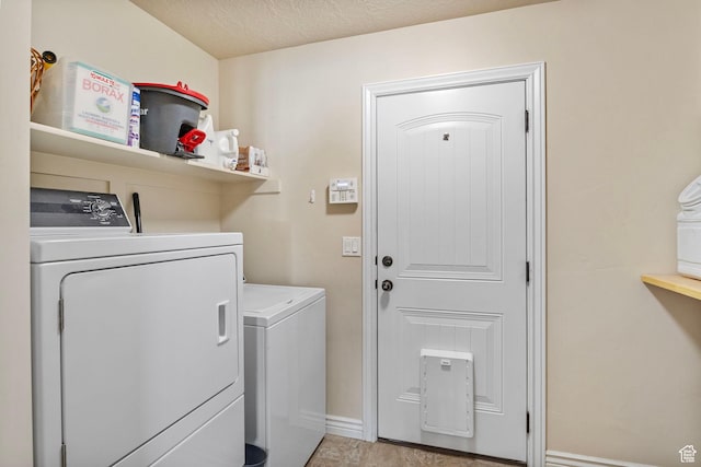 laundry area featuring baseboards, independent washer and dryer, and laundry area