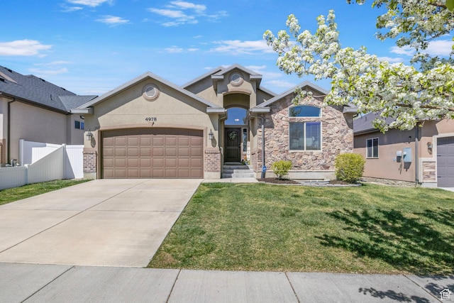 view of front of house with stone siding, a front lawn, fence, and a garage