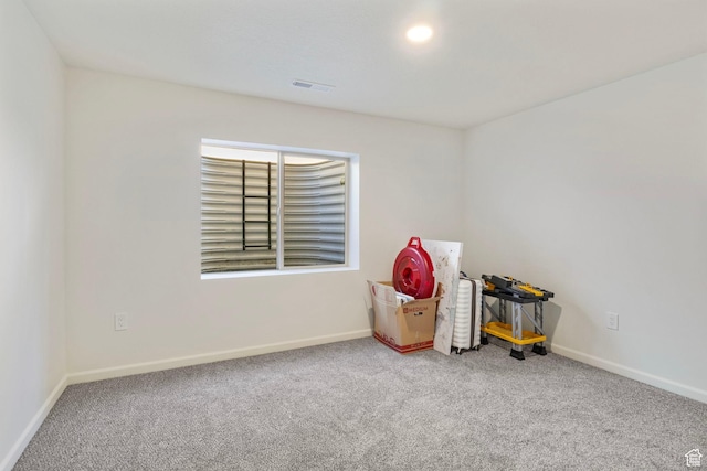 unfurnished room with carpet floors and baseboards