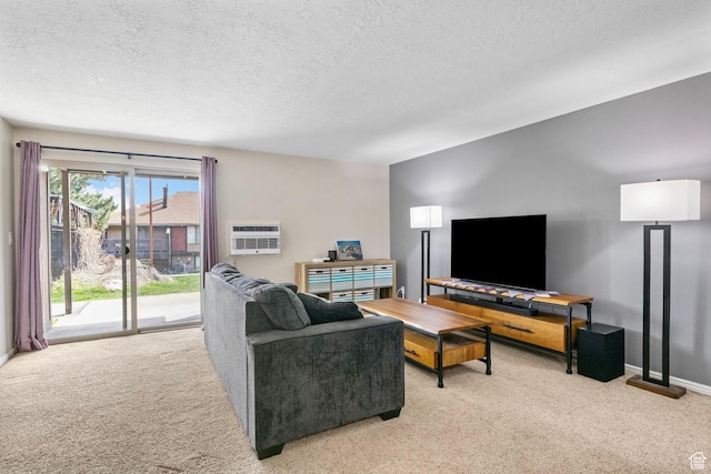 living room with a wall mounted air conditioner, light carpet, and a textured ceiling