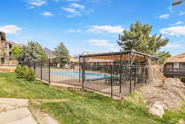 community pool with fence, a yard, and a patio