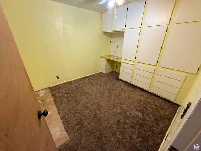 unfurnished bedroom featuring carpet floors and a textured wall