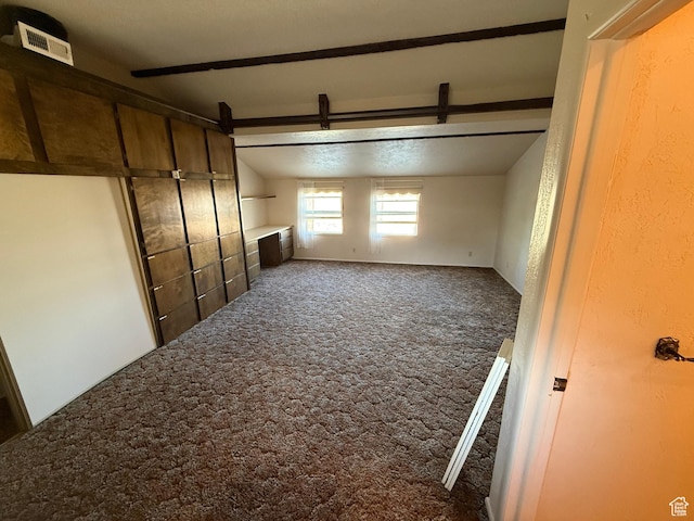 interior space featuring visible vents, carpet flooring, and lofted ceiling with beams