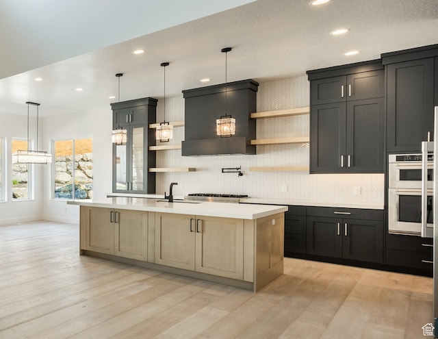 kitchen featuring open shelves, stainless steel double oven, a sink, light countertops, and tasteful backsplash