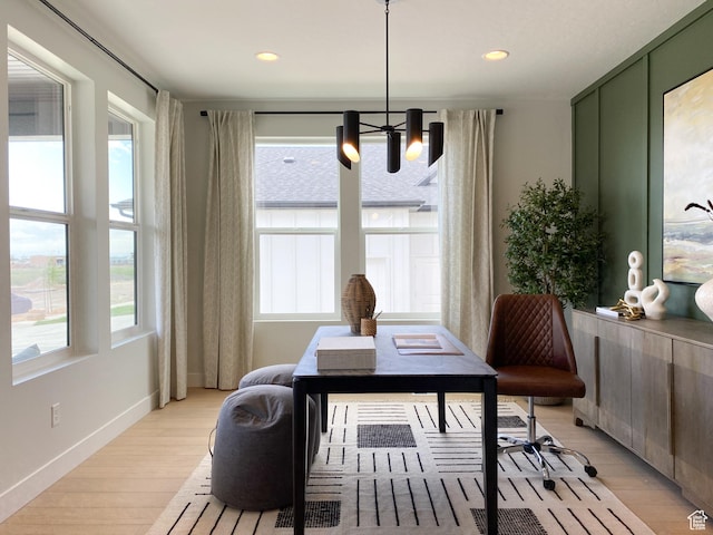 interior space with recessed lighting, baseboards, an inviting chandelier, and light wood-style flooring