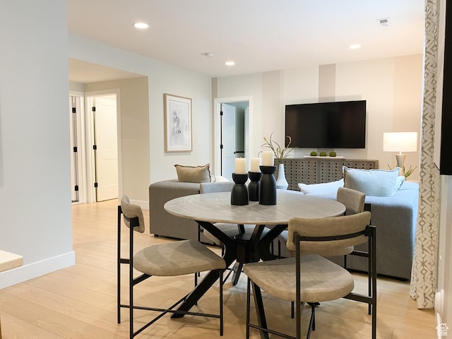 dining space with baseboards, light wood-style floors, visible vents, and recessed lighting