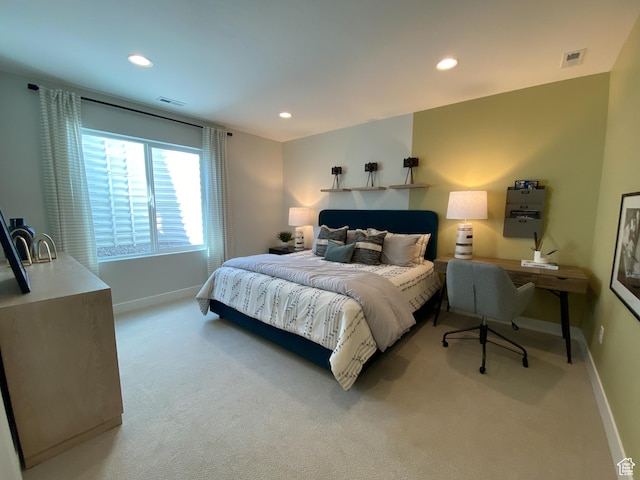 bedroom featuring light carpet, baseboards, and recessed lighting