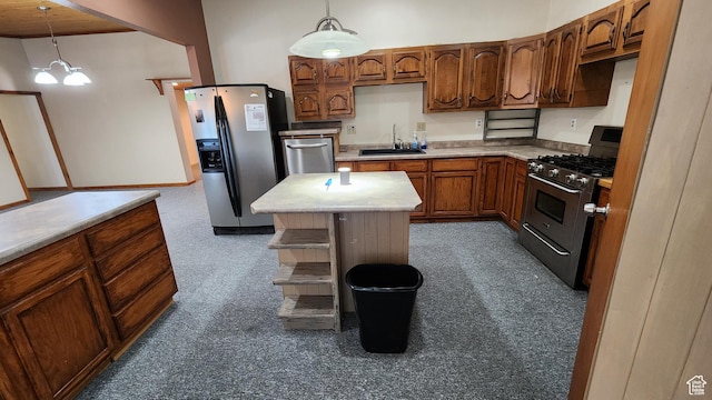 418 S 100 E, Wellington, UT 84542 - kitchen featuring appliances with stainless steel finishes, light countertops, decorative light fixtures, brown cabinetry, and carpet floors