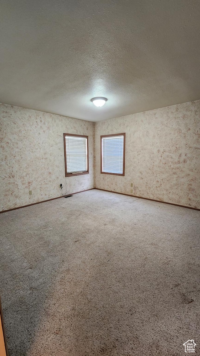 418 S 100 E, Wellington, UT 84542 - carpeted spare room featuring a textured ceiling