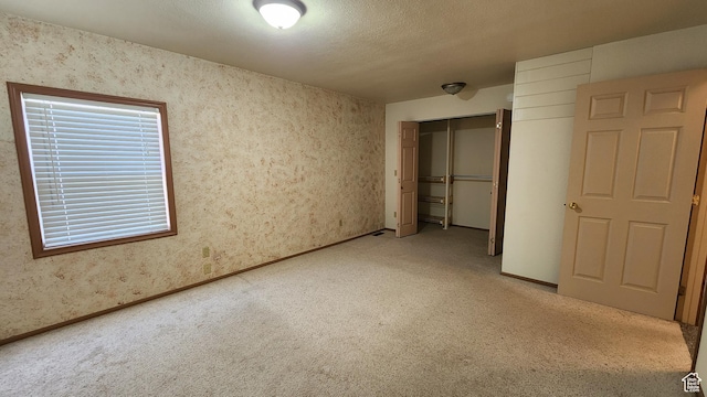 418 S 100 E, Wellington, UT 84542 - unfurnished bedroom with light carpet, a closet, and wallpapered walls