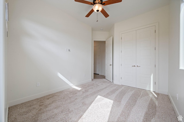unfurnished bedroom featuring baseboards, carpet flooring, and a closet