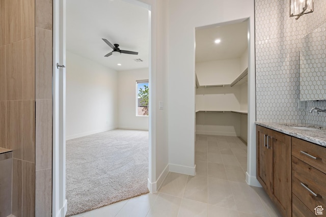 full bath with vanity, ceiling fan, baseboards, and tile patterned flooring