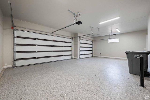 garage featuring baseboards and a garage door opener