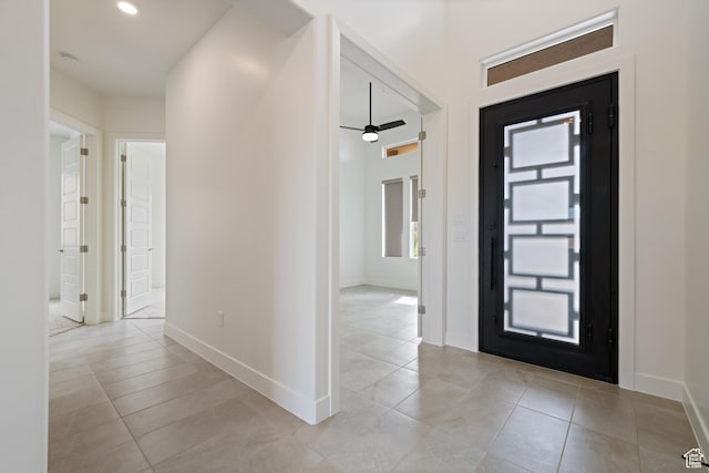 foyer entrance featuring ceiling fan, baseboards, recessed lighting, and light tile patterned floors