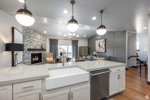 1166 W Cadence Ct, Kamas, UT 84036 - kitchen featuring stainless steel dishwasher, a sink, open floor plan, light countertops, and lofted ceiling