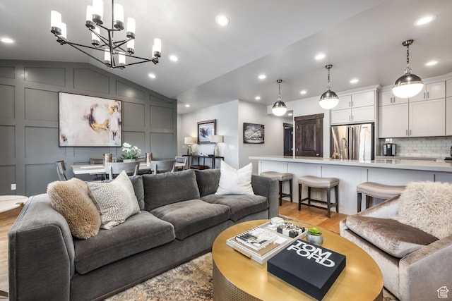 1166 W Cadence Ct, Kamas, UT 84036 - living room featuring vaulted ceiling, recessed lighting, a chandelier, light wood-style floors, and a decorative wall