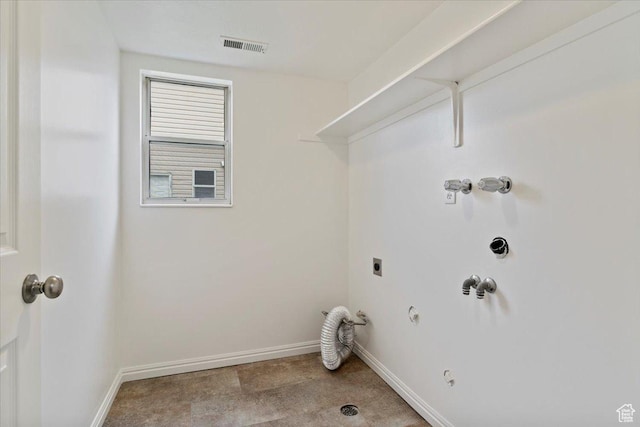 clothes washing area featuring hookup for an electric dryer, laundry area, hookup for a gas dryer, and baseboards