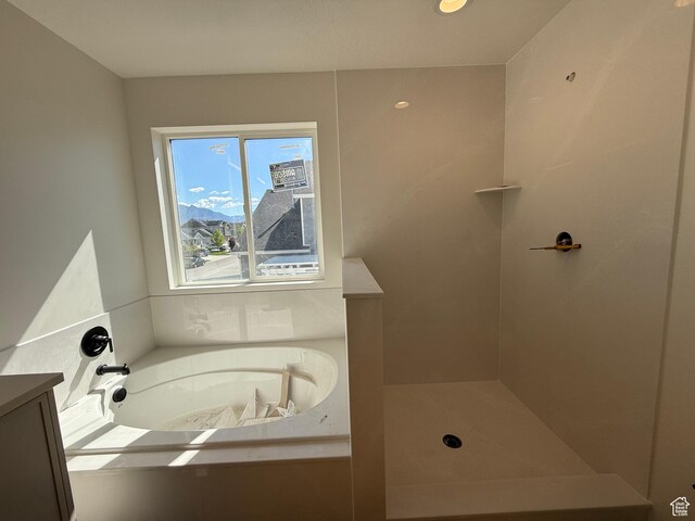 full bath featuring a garden tub and a shower