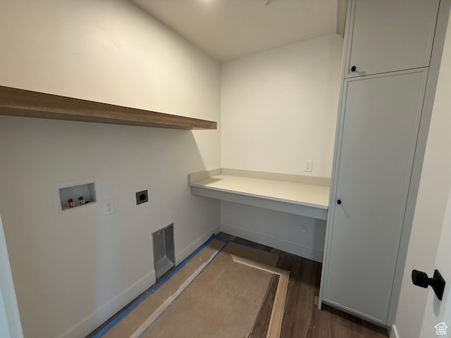 clothes washing area with electric dryer hookup, washer hookup, baseboards, and dark wood-type flooring