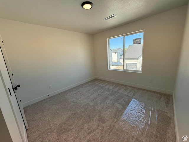 spare room with carpet flooring and baseboards