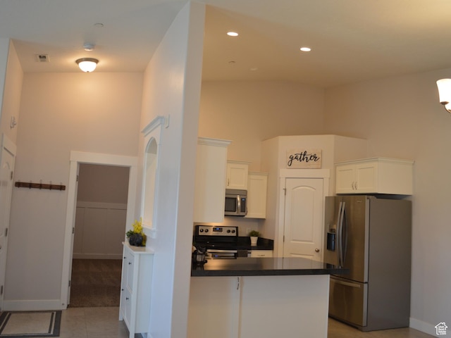 1921 N Crest Rd, Saratoga Springs, UT 84045 - kitchen with appliances with stainless steel finishes, dark countertops, a peninsula, white cabinets, and recessed lighting