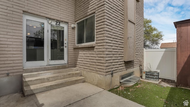 22 W La Vista Dr S, West Jordan, UT 84088 - view of exterior entry featuring fence and central AC