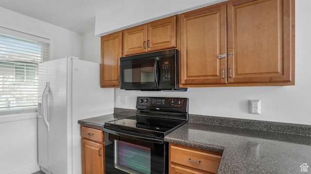 22 W La Vista Dr S, West Jordan, UT 84088 - kitchen featuring brown cabinetry, dark stone counters, and black appliances