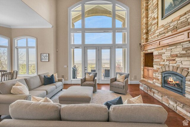 943 N Terrace Dr, Provo, UT 84604 - living area featuring wood finished floors, a stone fireplace, a high ceiling, and crown molding