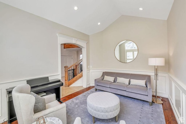 943 N Terrace Dr, Provo, UT 84604 - living room with arched walkways, a wainscoted wall, wood finished floors, and a decorative wall
