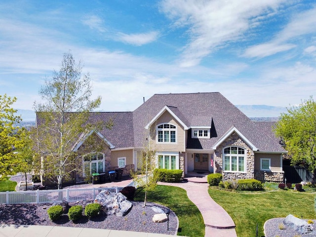943 N Terrace Dr, Provo, UT 84604 - view of front of house with stone siding, a front lawn, fence, and roof with shingles