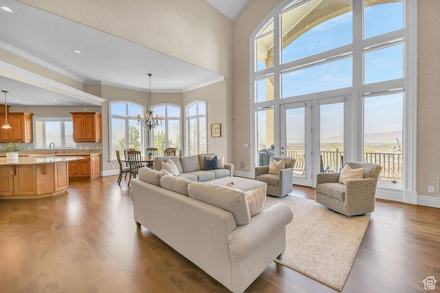 943 N Terrace Dr, Provo, UT 84604 - living area with baseboards, an inviting chandelier, recessed lighting, wood finished floors, and ornamental molding