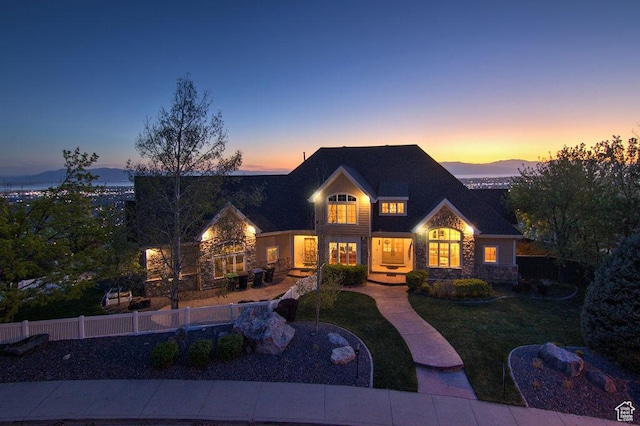 943 N Terrace Dr, Provo, UT 84604 - view of front facade with fence, a front yard, stone siding, and a mountain view