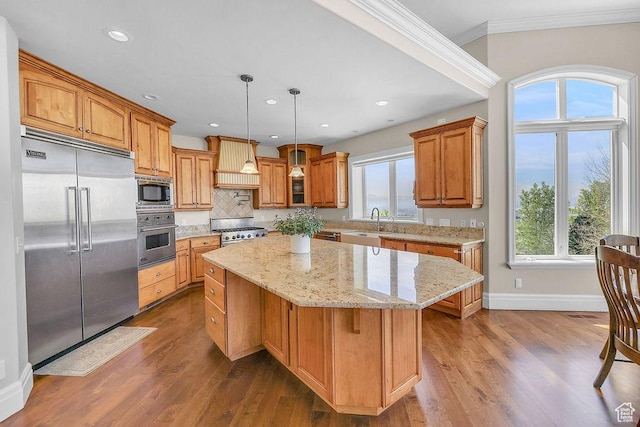 943 N Terrace Dr, Provo, UT 84604 - kitchen featuring baseboards, built in appliances, a kitchen island, ornamental molding, and premium range hood