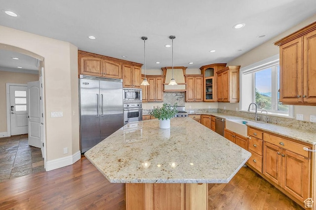 943 N Terrace Dr, Provo, UT 84604 - kitchen featuring light stone counters, a sink, built in appliances, custom range hood, and baseboards
