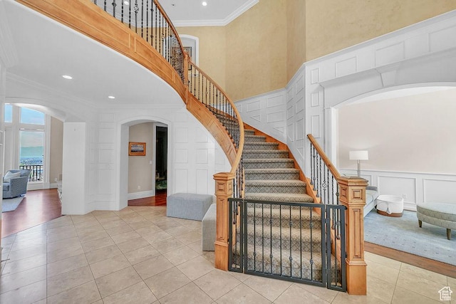 943 N Terrace Dr, Provo, UT 84604 - stairs with recessed lighting, tile patterned floors, ornamental molding, arched walkways, and a decorative wall
