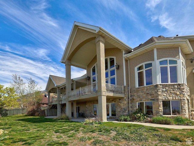 943 N Terrace Dr, Provo, UT 84604 - rear view of property with central AC unit, a balcony, stone siding, fence, and a yard