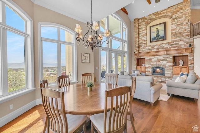 943 N Terrace Dr, Provo, UT 84604 - dining area with baseboards, a chandelier, wood finished floors, and a fireplace