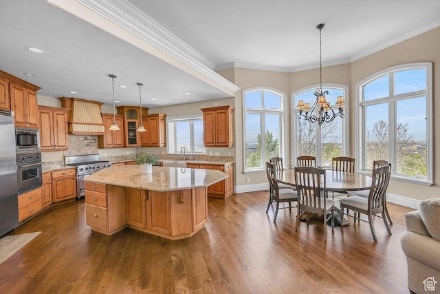 943 N Terrace Dr, Provo, UT 84604 - kitchen with stainless steel appliances, custom exhaust hood, a kitchen island, and a healthy amount of sunlight