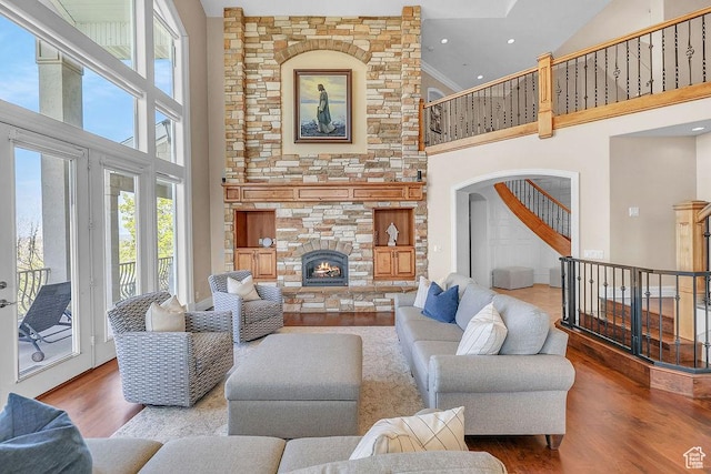 943 N Terrace Dr, Provo, UT 84604 - living area featuring recessed lighting, a high ceiling, wood finished floors, a fireplace, and stairs