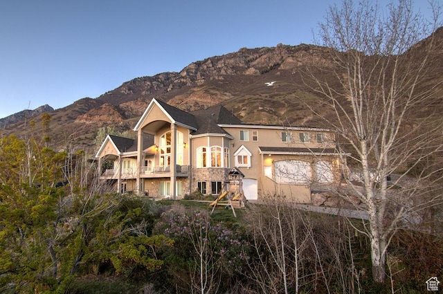 943 N Terrace Dr, Provo, UT 84604 - view of front of home with stucco siding, a mountain view, a balcony, and a garage
