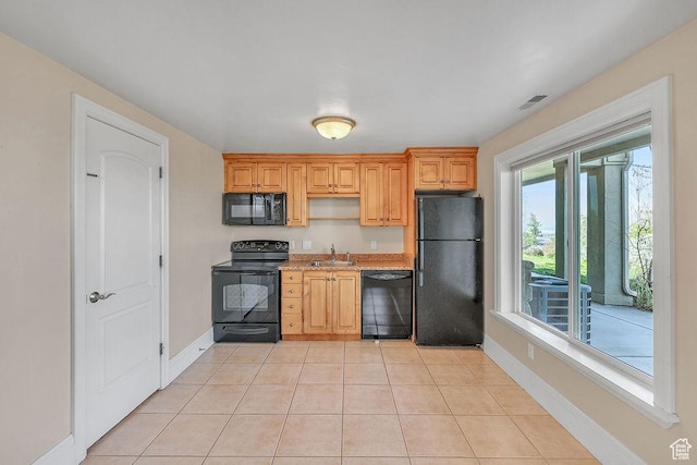 943 N Terrace Dr, Provo, UT 84604 - kitchen with a sink, black appliances, light tile patterned flooring, light countertops, and baseboards