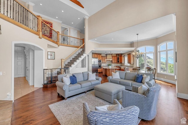 943 N Terrace Dr, Provo, UT 84604 - living room with crown molding, a towering ceiling, stairs, and an inviting chandelier