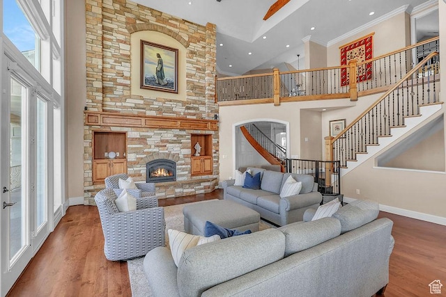 943 N Terrace Dr, Provo, UT 84604 - living room with stairway, wood finished floors, a towering ceiling, a fireplace, and baseboards