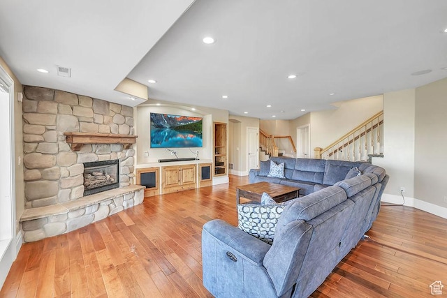943 N Terrace Dr, Provo, UT 84604 - living room with baseboards, visible vents, stairs, hardwood / wood-style floors, and a fireplace