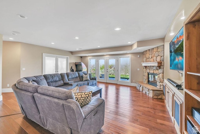 943 N Terrace Dr, Provo, UT 84604 - living room featuring a stone fireplace, hardwood / wood-style floors, french doors, baseboards, and recessed lighting