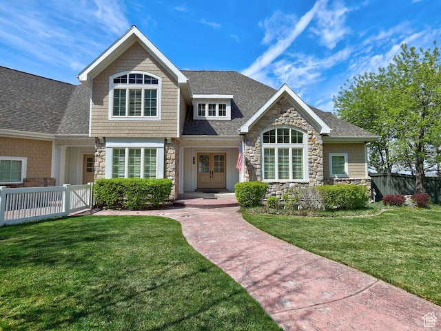 943 N Terrace Dr, Provo, UT 84604 - view of front of property featuring stone siding, a shingled roof, a front lawn, and fence