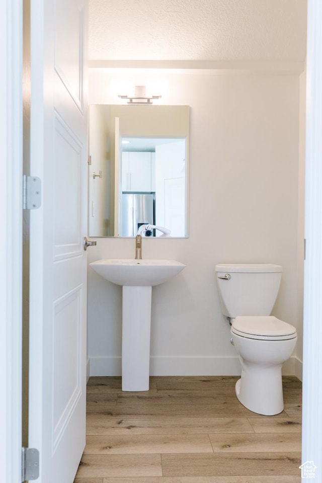 178 W Autumn Ln Unit 136, Saratoga Springs, UT 84045 - bathroom with baseboards, toilet, and wood finished floors