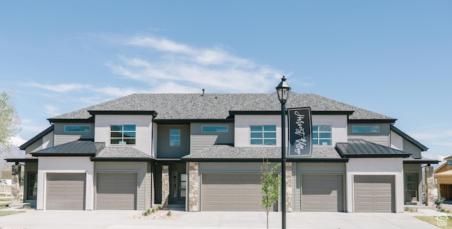 view of front of home with concrete driveway, stucco siding, and an attached garage