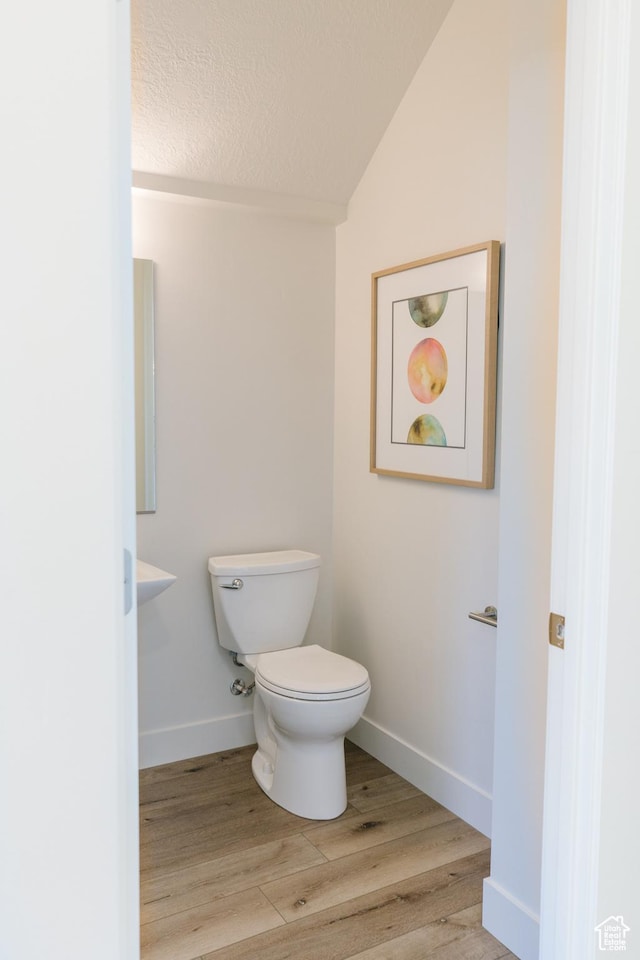 178 W Autumn Ln Unit 136, Saratoga Springs, UT 84045 - bathroom featuring a textured ceiling, toilet, wood finished floors, lofted ceiling, and baseboards